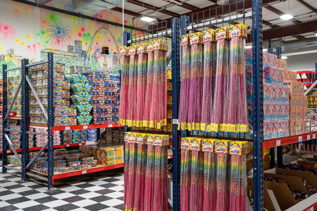 photo-molly-browns-fireworks-interior-2 Interior display at Molly Brown’s Fireworks showing hanging colorful sparklers and shelves stocked with fireworks.
